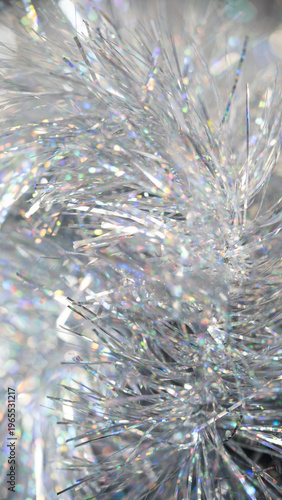 Shimmering silver tinsel strands with colorful reflections for festive decoration or craft use