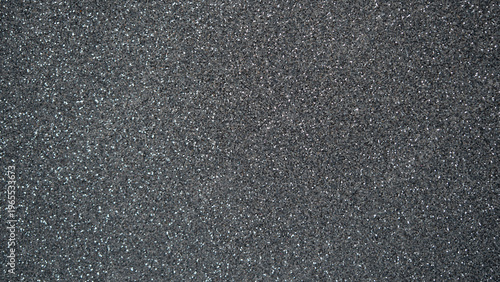 Textured dark gray surface with fine glitter particles, suitable for backgrounds and design projects
