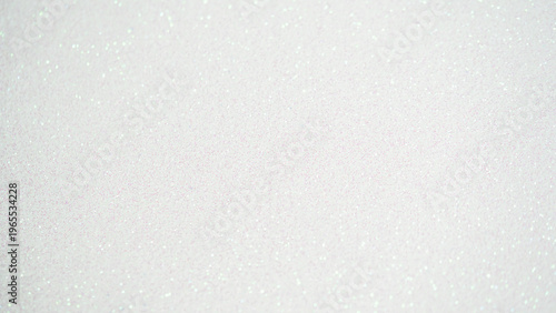 White glittery background texture with shimmering particles for design and creative projects