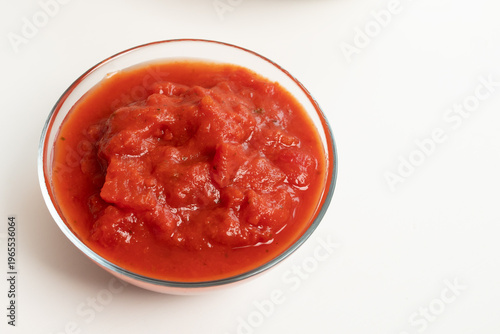 tomato sauce in a glass bowl on a white background, created as a clean cooking ingredient visual for recipe layouts, food packaging, kabsa preparation