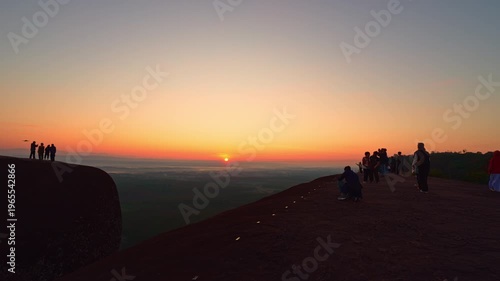 Bueng Kan, Thailand. 02 December 2025; Three Whale Rock Iconic Viewpoint of Northeastern Thailand. Epic sunrise at a famous Thai viewpoint, capturing tiny human figures on a colossal rock ledge