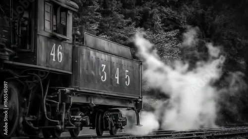 Vintage steam train locomotive in black and white detail on track