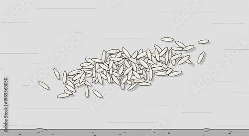 Close-up view of a pile of white rice grains scattered on a grey surface