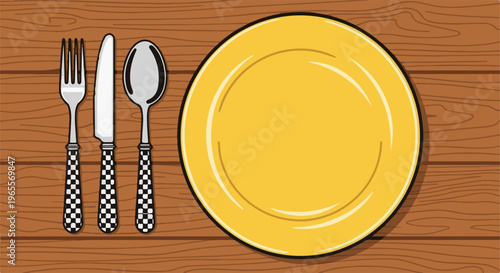 Overhead view of a yellow plate and silverware with checkered handles on wood