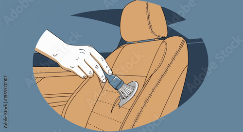 A hand uses a brush to clean a car's interior leather seat and headrest