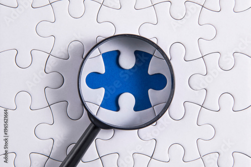 puzzle pieces with a magnifying glass	