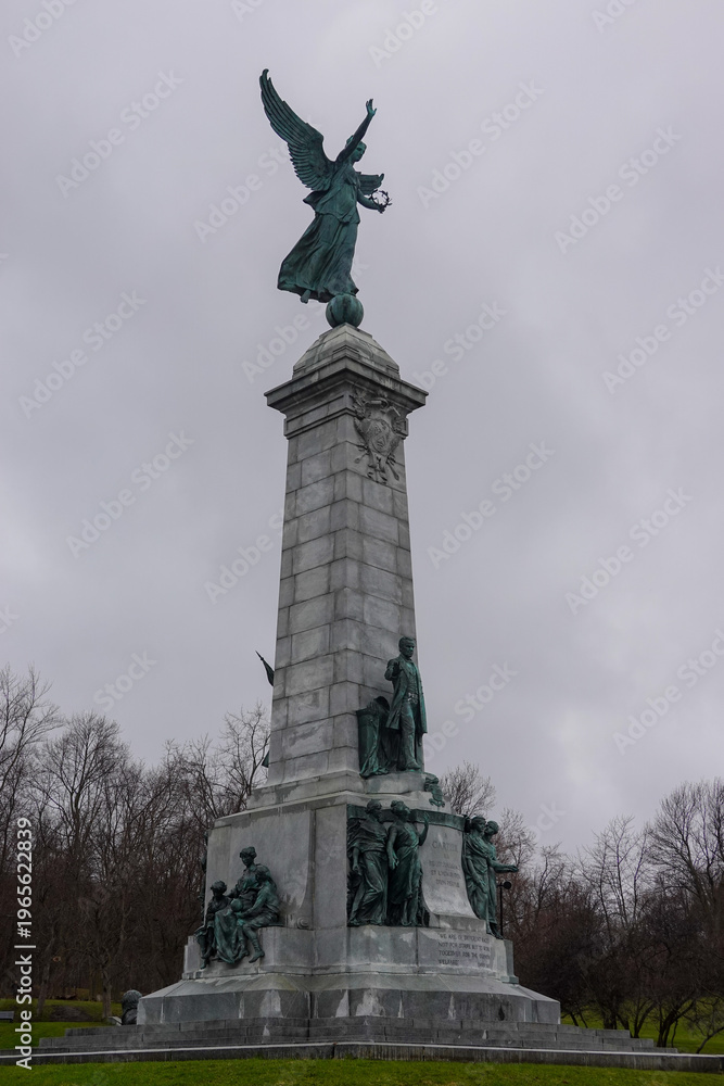 Fototapeta premium Monument With Statue Under Moody Gray Sky
