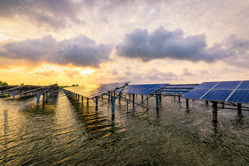 Floating solar panels on water surface at sunset, representing renewable energy, sustainable power generation and green technology for environmental protection.