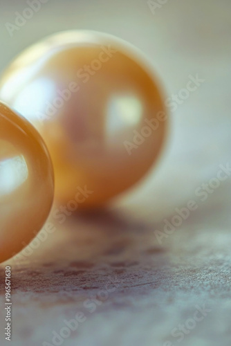 A pair of pearls sitting on a table, possibly for display or use in jewelry making