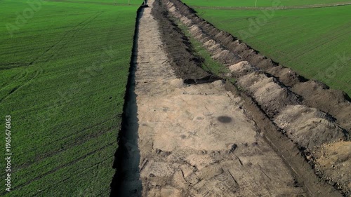  archaeological excavation or construction site where extensive earthworks have been carried out. exposed area with visible which is typical for archaeological surveys. pile of excavated soil, survey 