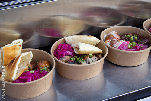 Food in paper bowls at the street food festival