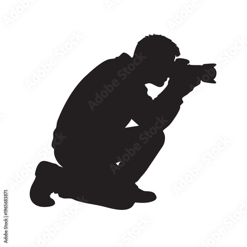 Photographer Silhouette Crouching and Focusing for Low Angle Creative Perspective.