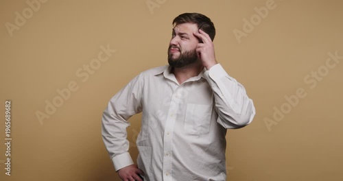Confused man shows a range of expressions while pondering a difficult question in a cozy studio setting