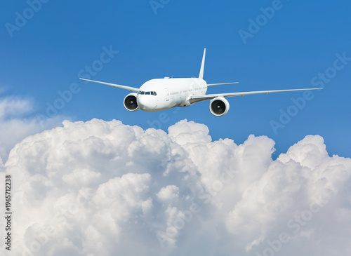 White passenger airplane flying in the sky amazing clouds in the background - Travel by air transport