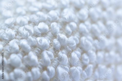 Soft white knitted texture close-up.