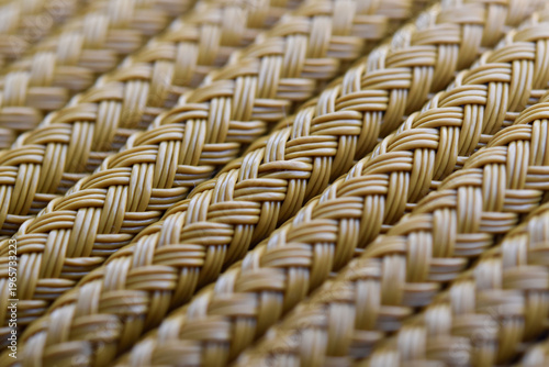 Brown woven plastic rattan texture close up.