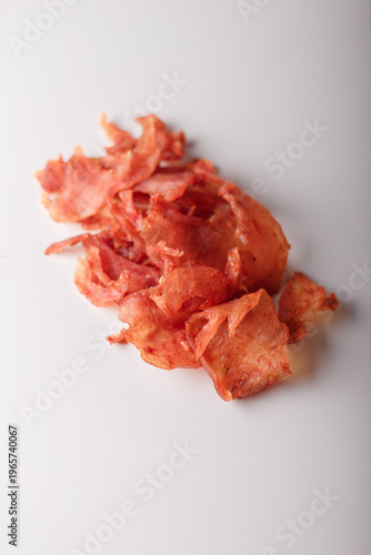 Dry chicken slices heap, jerky poultry meat pile on white background. Copy space, top view. Advertising banner, template. Product presentation. Vertical shot