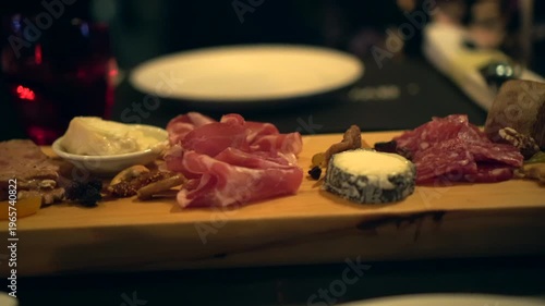 Cheeseboard variety of cheeses and cured meat wood platter wine appetizer 4k