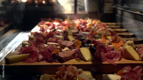 Cheeseboard variety of cheeses and cured meat wood platter wine appetizer