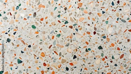Light grey terrazzo floor with colorful chips of orange green and blue texture background