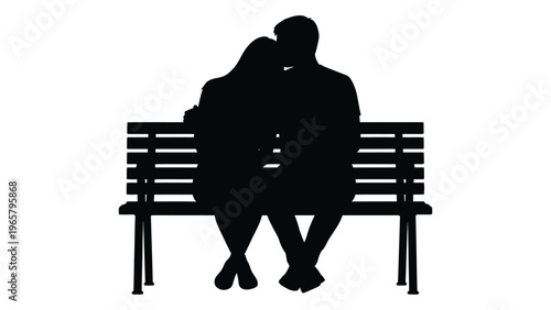 A couple sits closely together on a park bench embracing in a tender moment presented as a silhouette