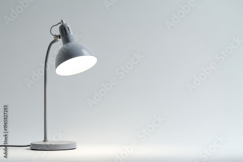 Sleek modern desk lamp with minimalist design on neutral background
