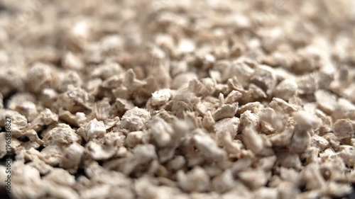 Falling pieces of biodegradable vegetable cat litter in slow motion. Macro shot. Plant-based absorbent material