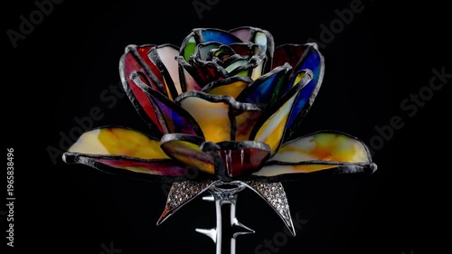 Striking image of a colorful helmet with intricate designs and decorative elements displayed on a dark background in a video