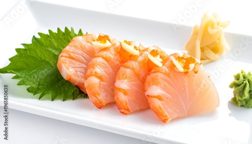 Close-up of sushi arrangement on a rectangular white plate, featuring salmon