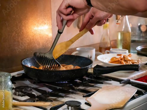 Man cooking prawns in kitchen. Chef frying seafood in black nonstick pan on stove burner. Process of preparing delicious healthy dinner. Culinary skills, home gastronomy and food concept.