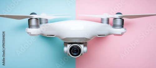 White drone with camera on a split pink and blue background.