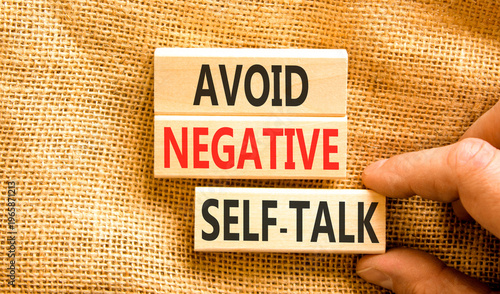Avoid negative self-talk symbol. Concept words Avoid negative self-talk on beautiful wooden blocks. Beautiful canvas background. Business psychology avoid negative self-talk concept. Copy space.
