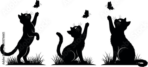 Three cats in silhouette jumping for butterflies in a grassy field