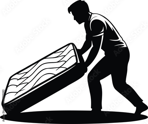 Man lifting and moving a mattress with effort and concentration  physical labor