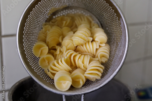 Boiled fusilli pasta being ...