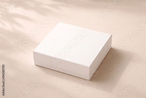 White Empty Rectangular Gift Box Displayed on a Clean Soft Beige Surface With Subtle Leaf Shadows Casting From Above, Suggesting a Minimalist Product Mockup or Packaging Design Concept