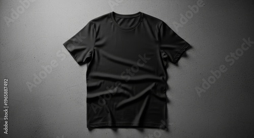 Blank Black Short Sleeve T-Shirt With a Crew Neck, Carefully Positioned on a Dark Gray Textured Background, Highlighting Its Smooth Fabric and Natural Folds for Design Display