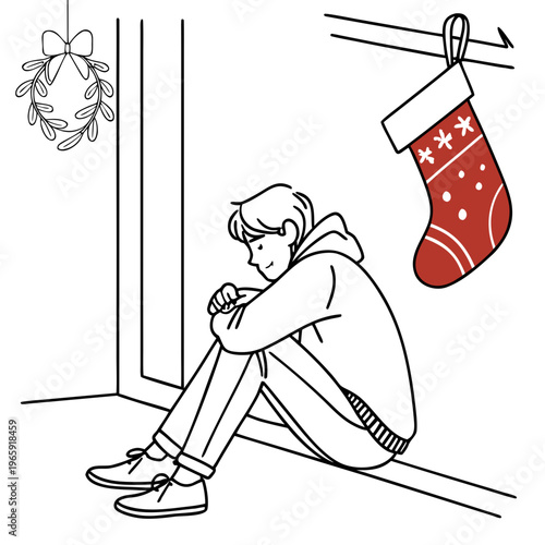 Young man sits alone near window during winter.