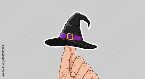 A hand balances a black witch's hat with a purple band and gold buckle