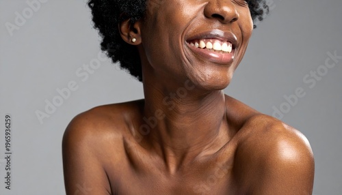 Radiant African American Woman with a Gleaming Smile and Bare Shoulders.