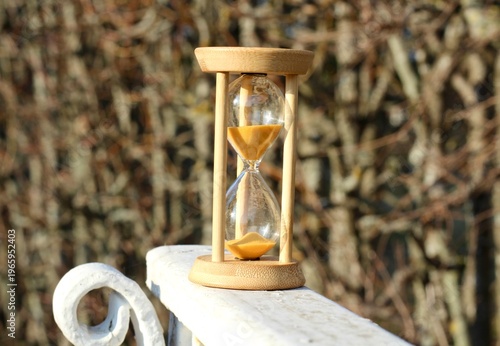 Hourglass on the stone surface concept of passing time hurry up live bein time 