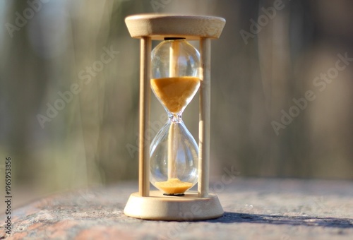 Hourglass on the stone surface concept of passing time hurry up live bein time 