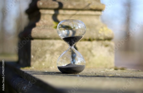 Old park and hourglass time is passing concept hurry up be in time old and modern 
