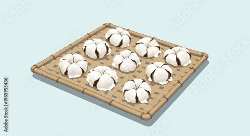 Numerous fluffy white cotton bolls rest on a woven bamboo tray