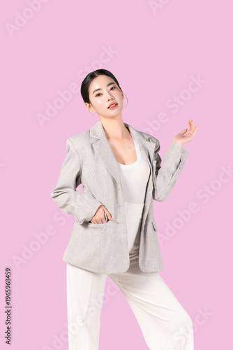 Confident young Asian woman with smooth healthy skin posing and body slim isolated on pink background for beauty, skincare and self care concept.