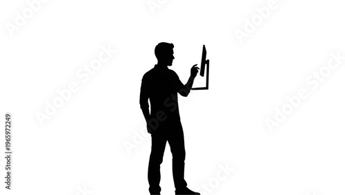 Silhouette of a man interacting with a digital tablet