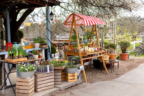 Wallpaper Mural Easter exterior market stall with spring flowers, wicker baskets, bunny shaped candles, and festive decorations. Cozy outdoor garden shop with blooming plants in pots and seasonal holiday display Torontodigital.ca