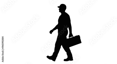 Silhouette of a man walking with a toolbox