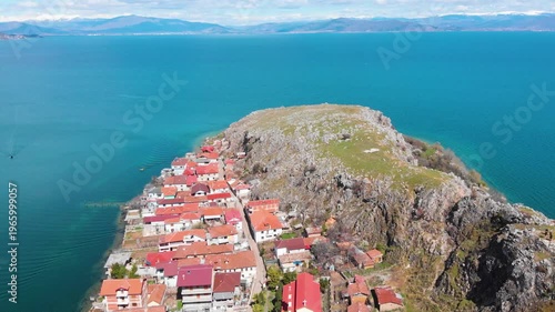 Village of Lin on the Rocky Peninsula Edge Along the Beautiful Shoreline of Lake Ohrid surrounded by emerald calm waters
