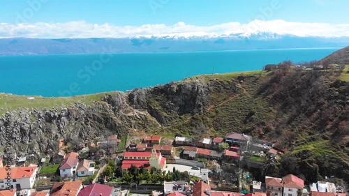 Village of Lin on the Rocky Peninsula Edge Along the Beautiful Shoreline of Lake Ohrid surrounded by emerald calm waters